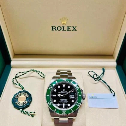 Rolex watch with green bezel in a branded box