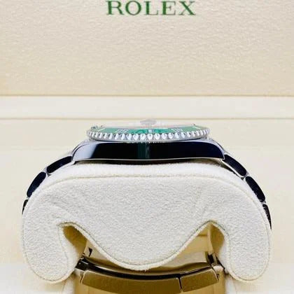 Rolex watch on a white cushion with 'Rolex' branding in the background