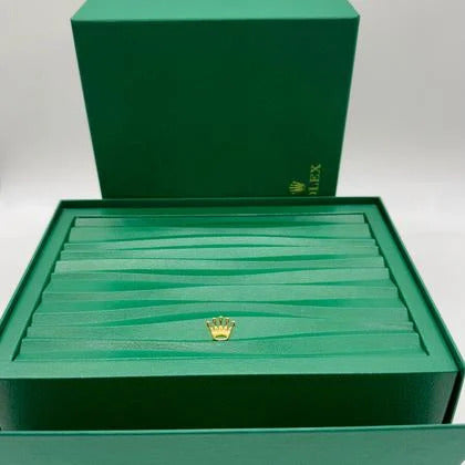 Green Rolex jewelry box with gold crown logo on a white background