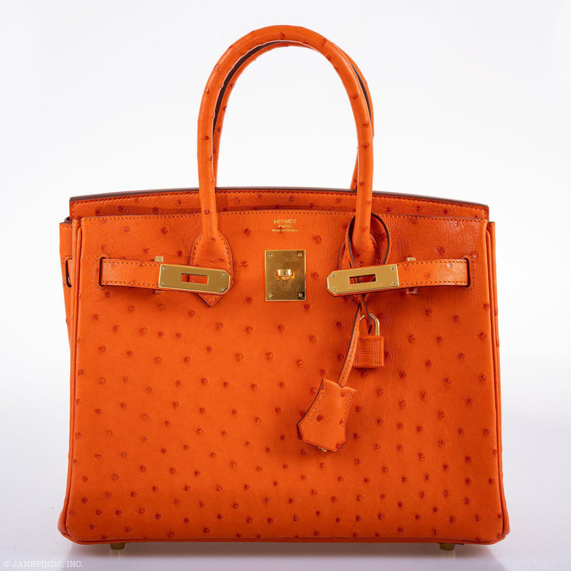 Lifestyle photo showcasing Birkin 30 in Tangerine Ostrich