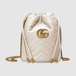Front view of the Gucci GG Marmont mini bucket bag in white matelassé leather