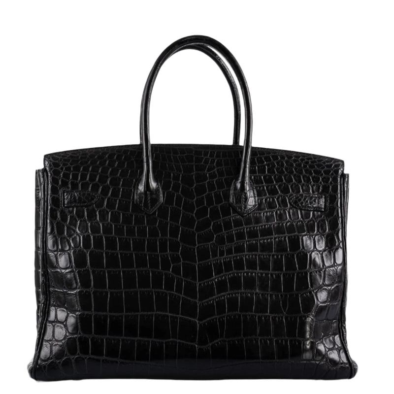 Flatlay of lock, keys, and clochette from Hermes Birkin set