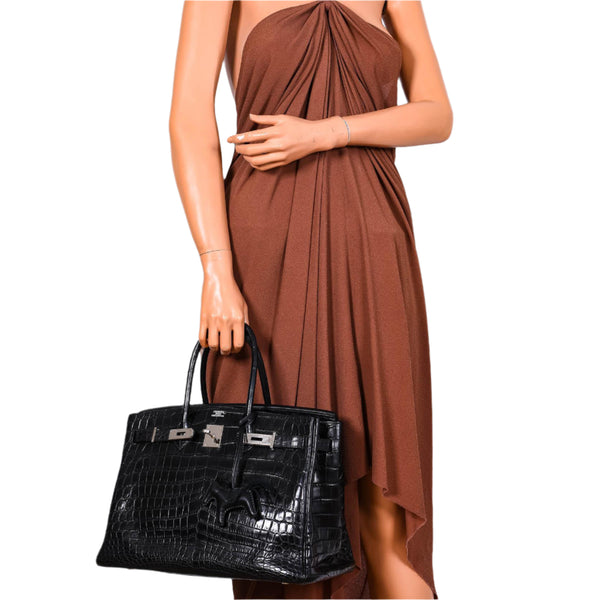 Side profile showing structured silhouette of matte black Birkin 35