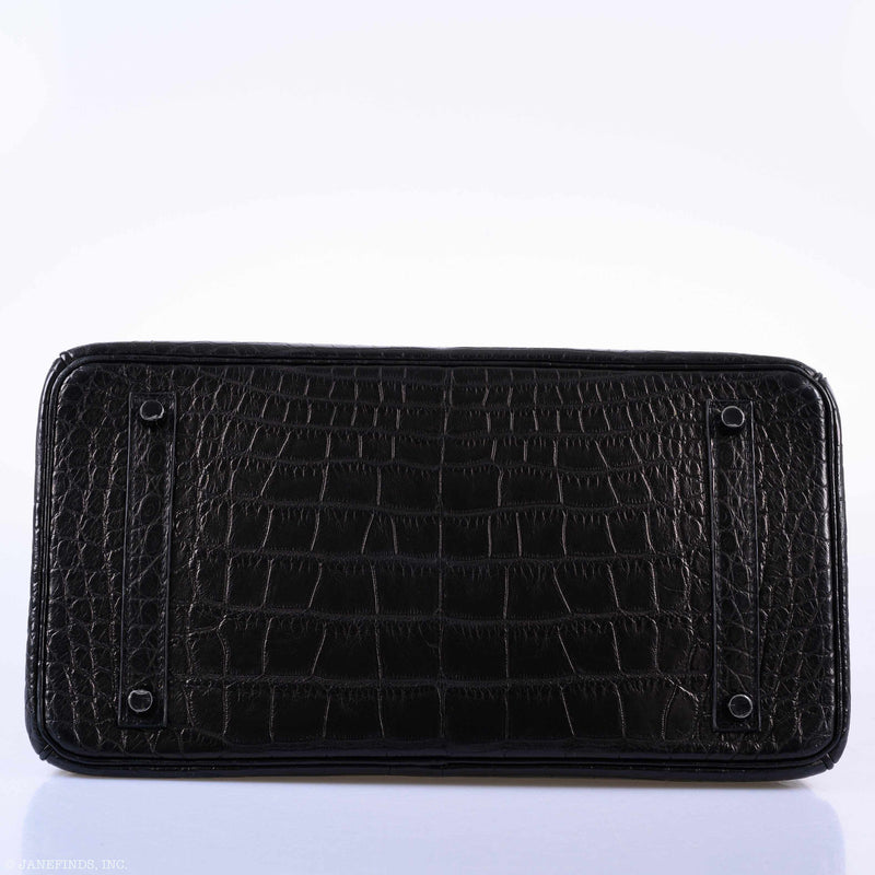 Close-up of black PVD hardware clasp and engraved Hermès detail