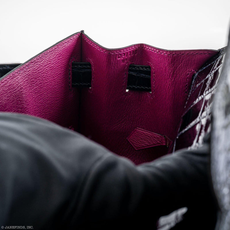 A close-up of the palladium turn-lock on the front of the bag