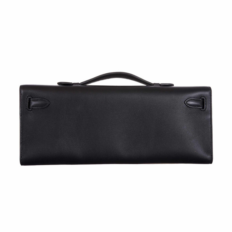 Close-up of top handle and gold clasp on Hermes Kelly Cut black Swift clutch.