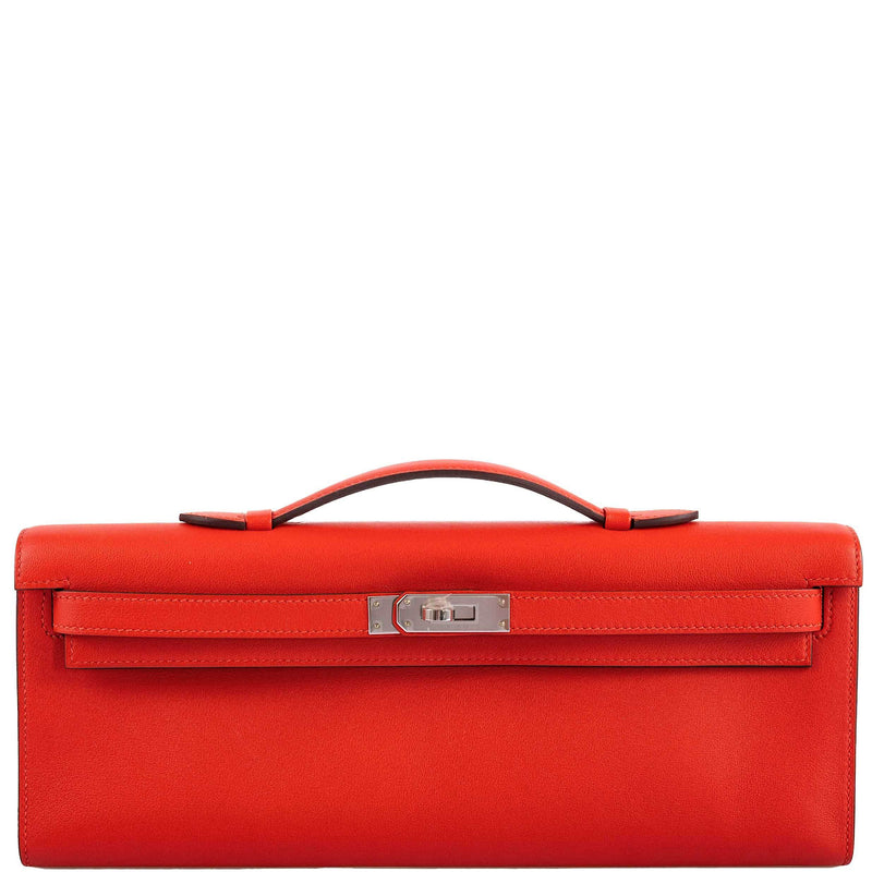 Hermes Kelly Cut clutch bag in Capucine Swift leather with palladium hardware.