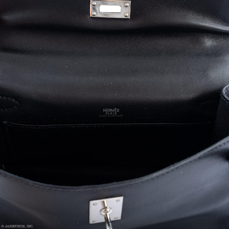 Detailed shot of strap and palladium clasp on Hermes Kelly Mini Pochette black Swift.