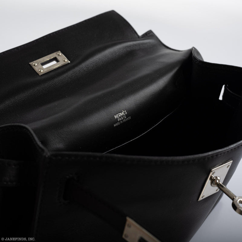 Top view of Hermes Kelly Mini Pochette black Swift leather with palladium hardware.
