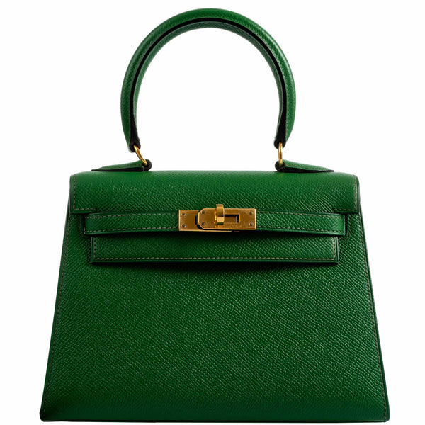 A detailed view of the gold-tone clasp and turn-lock closure on the Hermes Kelly Mini Pochette