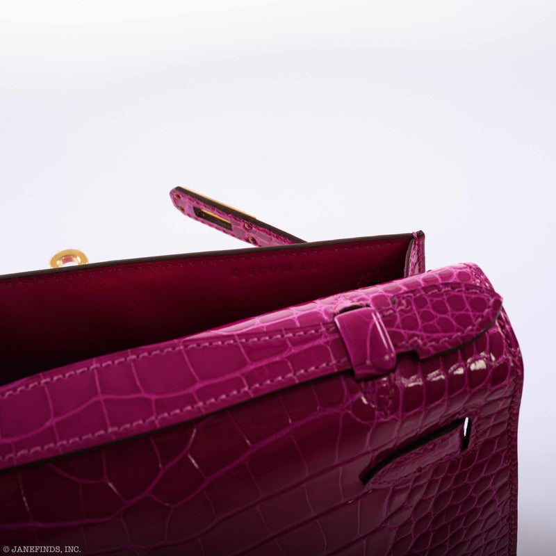 Angled view of Hermes Kelly Mini Pochette in Rose Scheherazade showing elegant silhouette