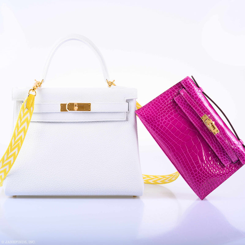 Flatlay of Hermes Kelly Mini Pochette in pink shiny alligator with gold hardware