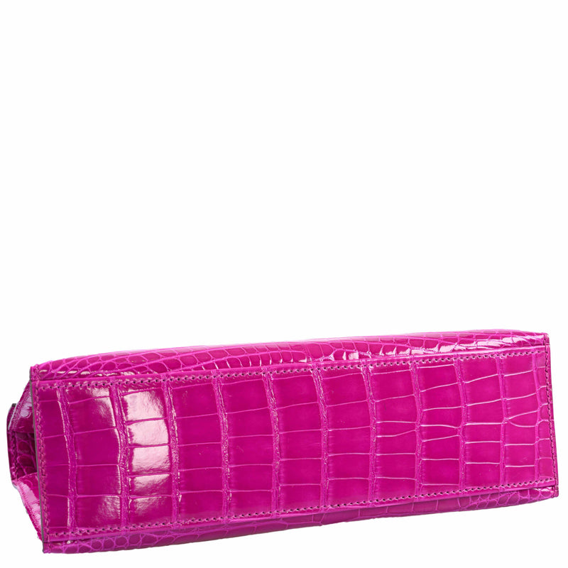 Gold hardware lock detail on the Hermes Kelly Mini Pochette in pink alligator leather