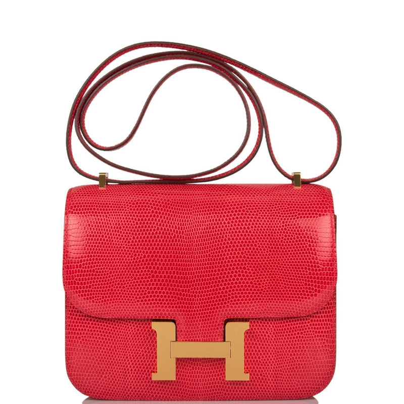 Hermes Mini Constance 18 handbag in Rouge Exotique Niloticus lizard with gold hardware.