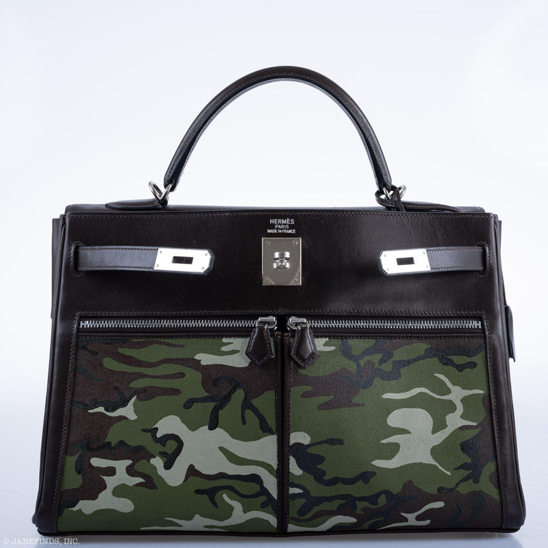Handle and palladium hardware detail on Kelly Lakis 35 camouflage painted bag